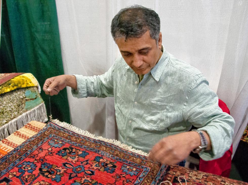 Suhail Bhatti of Oriental Rug Works in Keene repairs a rug for demonstration.  4-20-2015 Medora Hebert - 