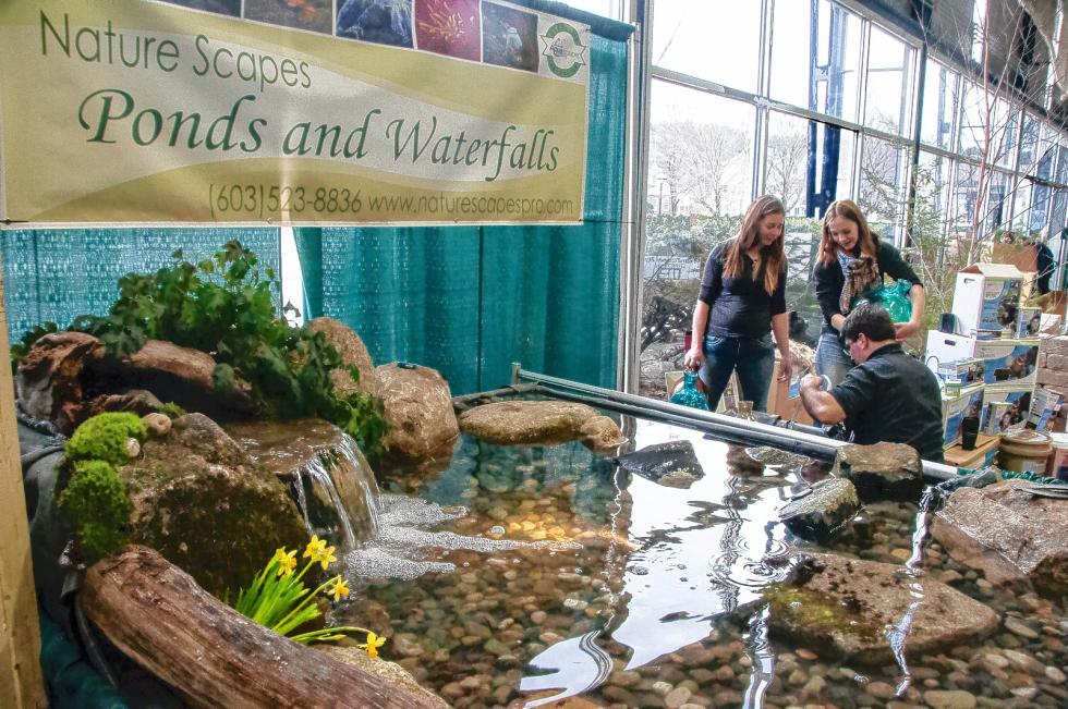 Nature Scapes of Grafton, makers of ponds and waterfalls, set up their display before the doors opened at the HomeLife Expo. From left are April Frost, Lindsay Dugan and Sean Frost. Medoar Hebert photograph -