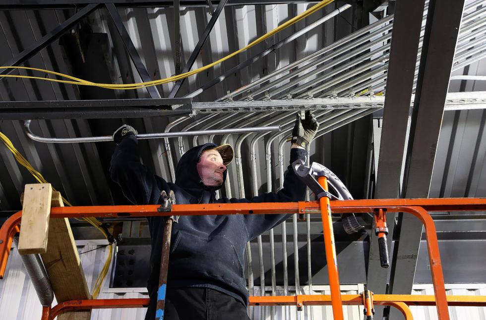 Jason St. Onge, of Tilton, N.H., installs conduit at the Tractor Supply store being built in Lebanon, N.H., on Feb. 25, 2015. Construction of the 19,000-square-foot store is scheduled to finish in May. (Valley News - Sarah Shaw) <p><i>Copyright © Valley News. May not be reprinted or used online without permission. Send requests to permission@vnews.com.</i></p> - Sarah Shaw | Valley News