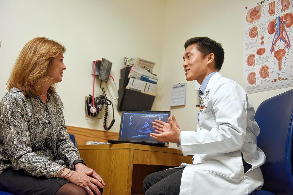 Kevin Koo, a urology resident, right, gives Donna Cauley of Manchester, Vt., good news during a follow-up appointment at Dartmouth-Hitchcock Medical Center in Lebanon, N.H., on March 25, 2015. (Valley News - Sarah Priestap) <p><i>Copyright © Valley News. May not be reprinted or used online without permission. Send requests to permission@vnews.com.</i></p> - Sarah Priestap | Valley News