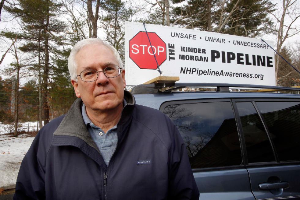 In this Thursday, March 26, 2015 photo, Homer Shannon poses at his home in Windham, N.H. The retired high-tech salesman is part of a 10-family group of neighbors opposed to a planned natural gas pipeline the would run right by his property behind him. (AP Photo/Jim Cole) - Jim Cole | AP