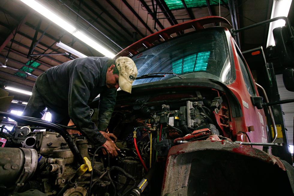 Mechanic Greg Pierce works to replace the head gasket of a town plow truck at the Freightliner dealership in Lebanon, N.H., on April 3, 2015. The building's owner, Champlain Oil, is planning to reconfigure the Heater Road property with an all-new dealership, truck stop and renovated restaurant. (Valley News - Geoff Hansen) Copyright Â© Valley News. May not be reprinted or used online without permission. Send requests to permission@vnews.com. - Geoff Hansen | Valley News