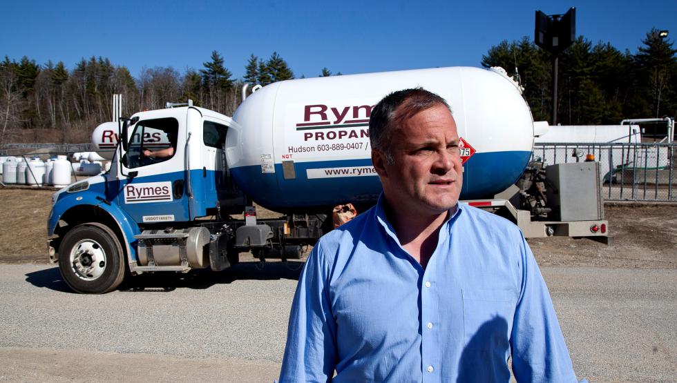 John Rymes in front of one the Fuller trucks the company got when the Rymes bought the Fuller company last year.  (GEOFF FORESTER / Monitor staff) - Concord Monitor