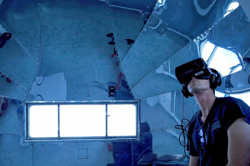 Mitch Swenson plays a virtual reality game using the Oculus Rift Development Kit 2 inside a custom-made Airstream trailer at the IndieCade festival in Culver City, Calif., on Saturday, Oct. 11, 2014. (Allen J. Schaben/Los Angeles Times/MCT) - Allen J. Schaben | Los Angeles Times