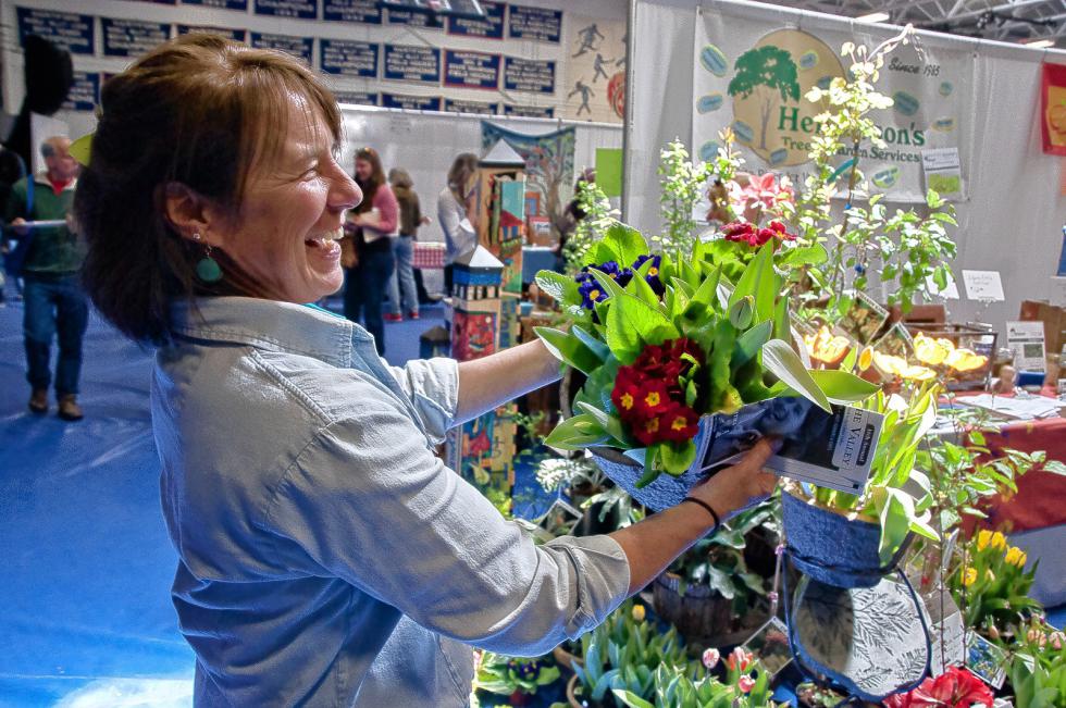 Sylvia Provost, owner of Henderson's Tree and Garden Service in White River Junction, Vt., shows off some spring flowers. (Medora Hebert photograph) -