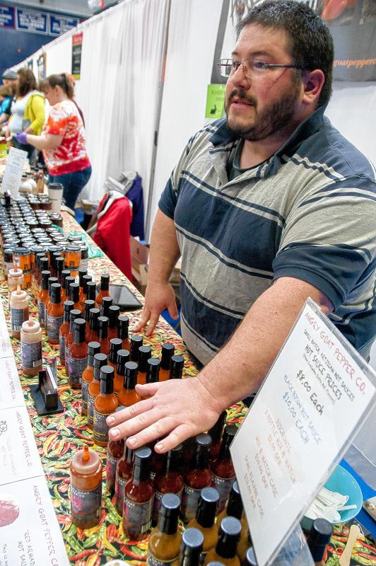 Jason Parker, owner of the Angry Goat Pepper Co., talks about his artisanal hot sauces. The company is located in Bradford, Vt. (Medora Hebert photograph) - 