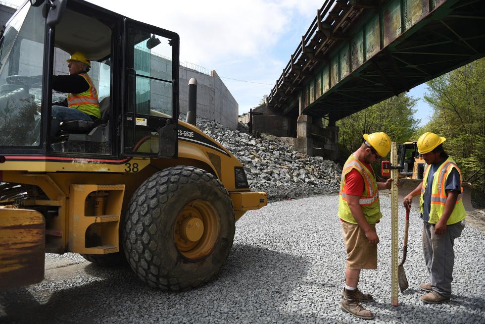 Zachary Blanchette, left, and Gurllermo Cuevas of Audley Construction measure what will be a crane pad at the Rt. 4 bridge construction in Lebanon, N.H. on May 18, 2015.  (Valley News - Jennifer Hauck) Copyright © Valley News. May not be reprinted or used online without permission. Send requests to permission@vnews.com. - Jennifer Hauck | Valley News