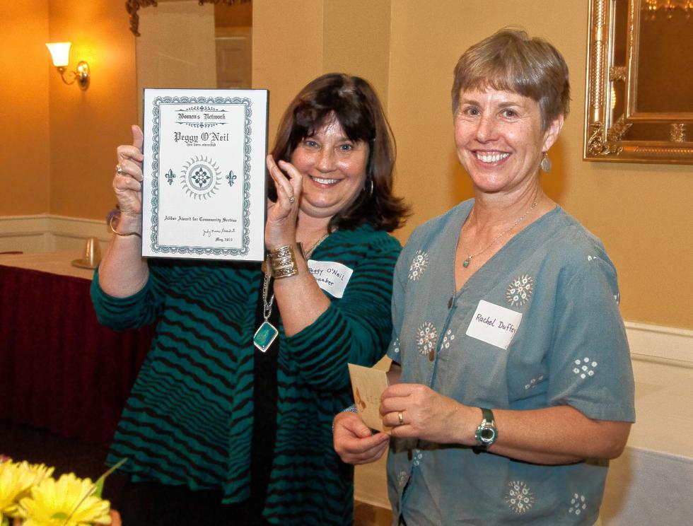 Peggy O’Neil, left, executive director of WISE, shows off her Deborah Aliber Award for Community Service. The award was presented by Rachel Duffy, right, the daughter of the late Deborah Aliber, whose family created the award. WISE was started in 1974 to help disadvantaged women while promoting human rights and social justice. Medora Hebert photograph - 
