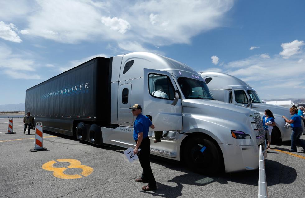 People load in to a Daimler Freightliner Inspiration self-driving truck for a demonstration Wednesday, May 6, 2015, in Las Vegas. Although much attention has been paid to autonomous vehicles being developed by Google and traditional car companies, Daimler believes that automated tractor-trailers will be rolling along highways before self-driving cars are cruising around the suburbs. (AP Photo/John Locher) - John Locher | AP