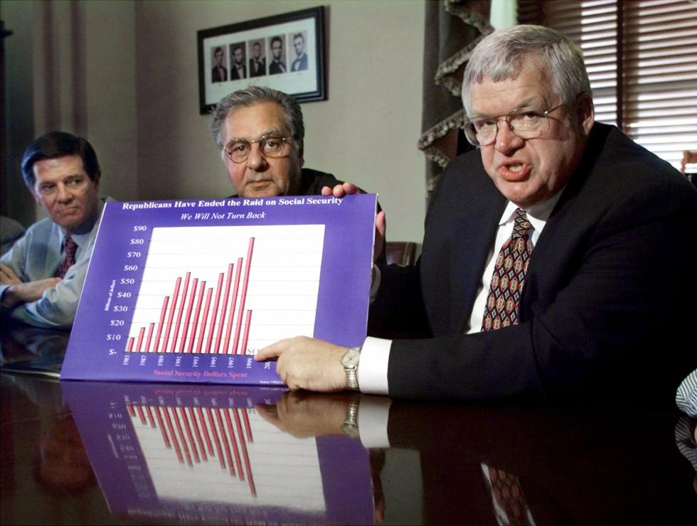 FILE - In this Oct. 12, 1999 file photo, Speaker of the House Dennis Hastert, R-Ill., right, holds a poster which reads "Republicans Have Ended the Raid on Social Security" during a press conference outlining the leaders' plans for dealing with the U.S. budget surplus on Capitol Hill in Washington. From left are House Majority Whip Tom DeLay, R-Texas, and House Majority Leader Dick Armey, R-Texas.  A newly unveiled indictment against Hastert released Thursday, May 28, 2015,  accuses the Republican of agreeing to pay $3.5 million in hush money to keep a person from the town where he was a longtime schoolteacher silent about "prior misconduct."  (AP Photo/Khue Bui, File) - Khue Bui | AP