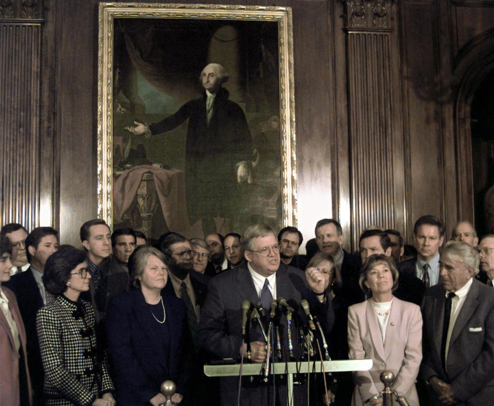 FILE - In this Jan. 5, 1999 file photo, under a portrait of George Washington, Rep. Dennis Hastert, R-Ill., accompanied by wife Jane, next to him left, and fellow Republicans, meets reporters on Capitol Hill after being nominated by House Republicans to become the next House speaker.  A newly unveiled indictment against Hastert released Thursday, May 28, 2015,  accuses the Republican of agreeing to pay $3.5 million in hush money to keep a person from the town where he was a longtime schoolteacher silent about "prior misconduct."  (AP Photo/Greg Gibson, File) - Greg Gibson | AP