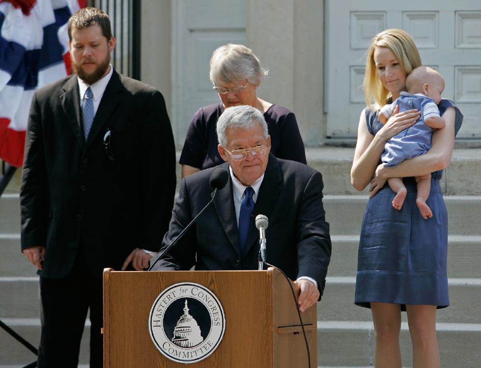 FILE - In this  Aug. 17, 2007, file photo, Rep. J. Dennis Hastert, front, R-Ill., announces that he will not seek reelection for a 12th term as he stands on the steps of the old Kendall County courthouse with, from left, his son Josh; wife Jean; and daughter-in-law Heidi, grandson Jack, in Yorkville, Ill.  A newly unveiled indictment against Hastert released Thursday, May 28, 2015,  accuses the Republican of agreeing to pay $3.5 million in hush money to keep a person from the town where he was a longtime schoolteacher silent about "prior misconduct."  (AP Photo/Brian Kersey, File) - Brian Kersey | AP