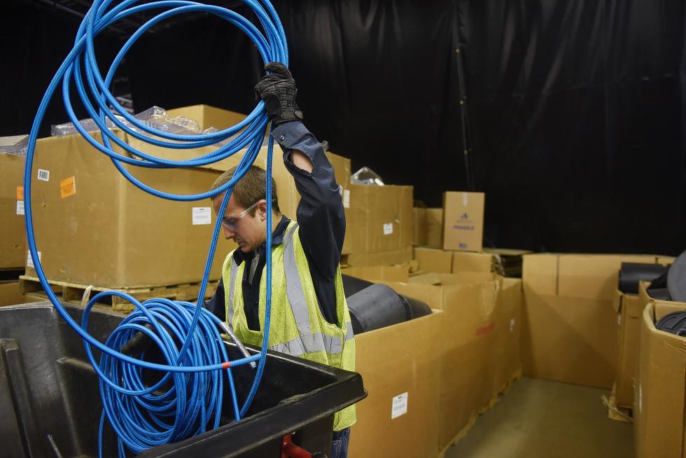 Alex Poisson, recycling driver for Casella Waste Systems, organizes a length of nylon-coated rubber hose at the sorting facility in Lebanon, N.H., on May 22, 2015. Poisson said that while products like the nylon hoses that come from Hypertherm cannot be conventionally recycled at the moment, Casella workers are storing products while they come up with creative recycling solutions. (Valley News - Sarah Priestap) Copyright © Valley News. May not be reprinted or used online without permission. Send requests to permission@vnews.com. - Sarah Priestap | Valley News