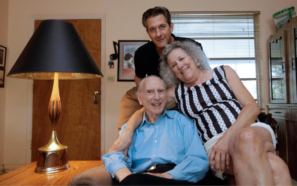 In this May 11, 2015 photo, Larry Karp, top, poses for photos with his parents, Al Karp, left, and Saundra, at their home in North Miami Beach, Fla. The trio performs old standards locally as the Karp Family to ease stress and help raise money to save their home from foreclosure. (AP Photo/Alan Diaz) - Alan Diaz | AP