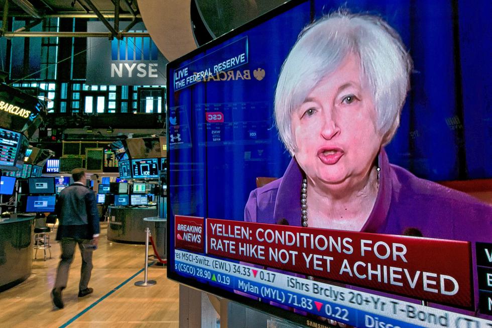 The press conference of Federal Reserve Chairperson Janet Yellen appears on a television screen on the floor of the New York Stock Exchange, Wednesday, June 17, 2015. The U.S. economy has strengthened since a slump early this year, the Federal Reserve said Wednesday, but it wants to see further gains in the job market and higher inflation before raising interest rates from record lows.  (AP Photo/Richard Drew) - Richard Drew | AP