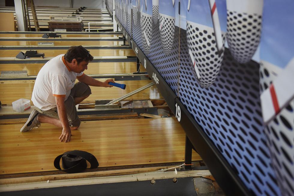 Maple Lanes manager Shawn Fitzpatrick Sr. inspects the recently finished synthetic lanes installed at Maple Lanes in Claremont, N.H., on June 12, 2015. The lanes and ball returns were purchased from the now-closed Upper Valley Lanes and Games in White River Junction, Vt. (Valley News - Sarah Priestap) Copyright © Valley News. May not be reprinted or used online without permission. Send requests to permission@vnews.com. - Sarah Priestap | Valley News