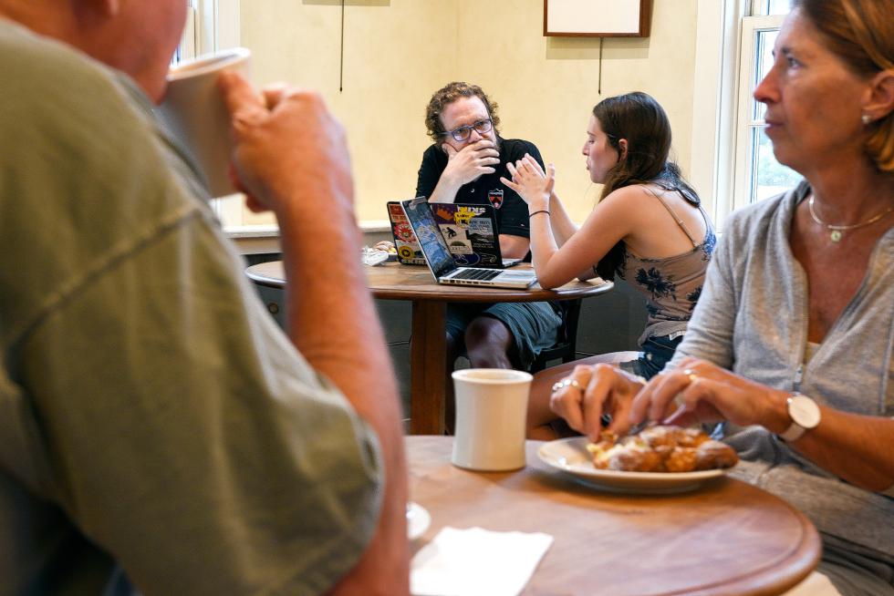 During his twice-weekly office hours at Umpleby's Cafe in Hanover, N.H. computer science professor Sean Smith, 50, talks with student Emily Dann, of Manhattan, N.Y. about her project for the class Wednesday, July 15, 2015. Smith came to Dartmouth College in 2000 after working in information security at the Los Alamos National Laboratory and IBM. (Valley News - James M. Patterson) <p><i>Copyright Â© Valley News. May not be reprinted or used online without permission. Send requests to permission@vnews.com.</i></p> - James M. Patterson | Valley News