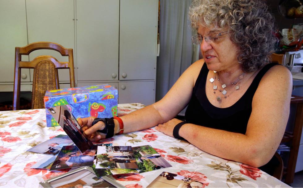In this July 1, 2015 photo, Roslyn Duffy looks through photos of her late mother, Evelyn Nappa, at her home in Seattle. Duffy had to scramble to find a home willing to take Medicaid payments after her mother was evicted from a Seattle assisted-living facility. The stress and the change of surroundings strained her mother's health, Duffy said, and six weeks after moving, she was dead. (AP Photo/Ted S. Warren) - Ted S. Warren | AP