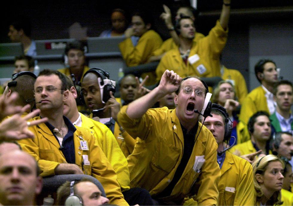 FILE - In this Sept. 16, 2003 file photo, clerks shout in the Euro Dollar Futures pit at the Chicago Mercantile Exchange. Most pits in Chicago and New York where traders bet on future prices of palladium and gold, cattle and corn and dozens of other commodities are expected to close for good on Monday, July 6, 2015. (AP Photo/Anne Ryan, File) - ANNE RYAN | AP