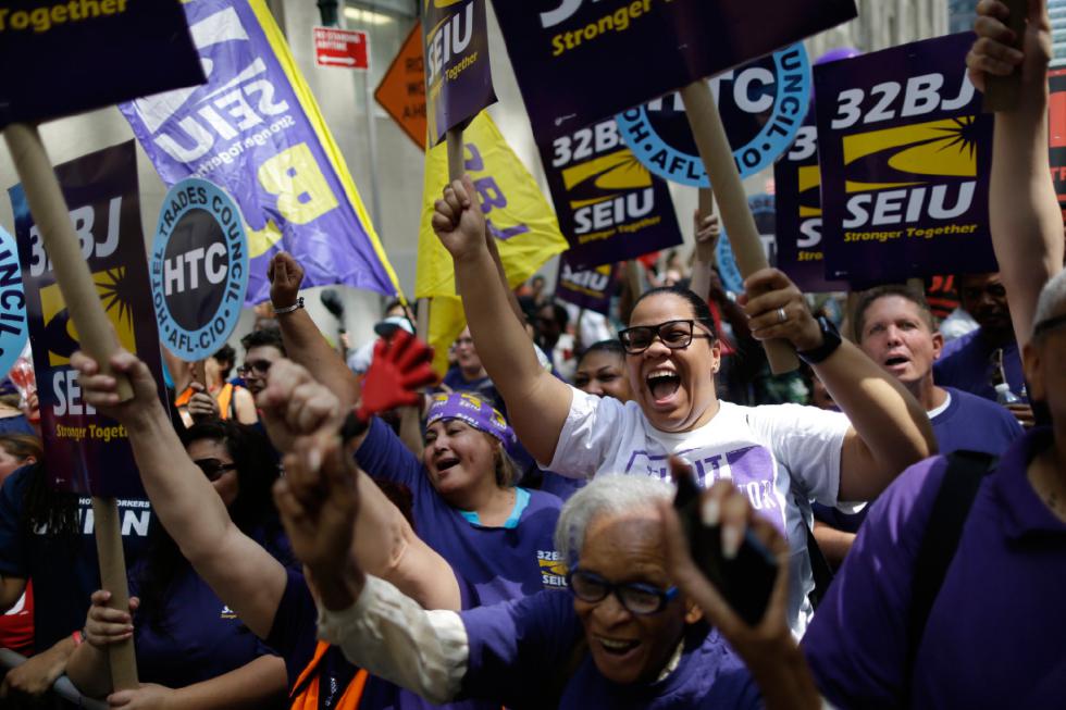 Activists cheer during a rally after the New York Wage Board endorsed a proposal to set a $15 minimum wage for workers at fast-food restaurants with 30 or more locations, Wednesday, July 22, 2015 in New York. The increase would be phased in over three years in New York City and over six years elsewhere. (AP Photo/Mary Altaffer) - Mary Altaffer | AP
