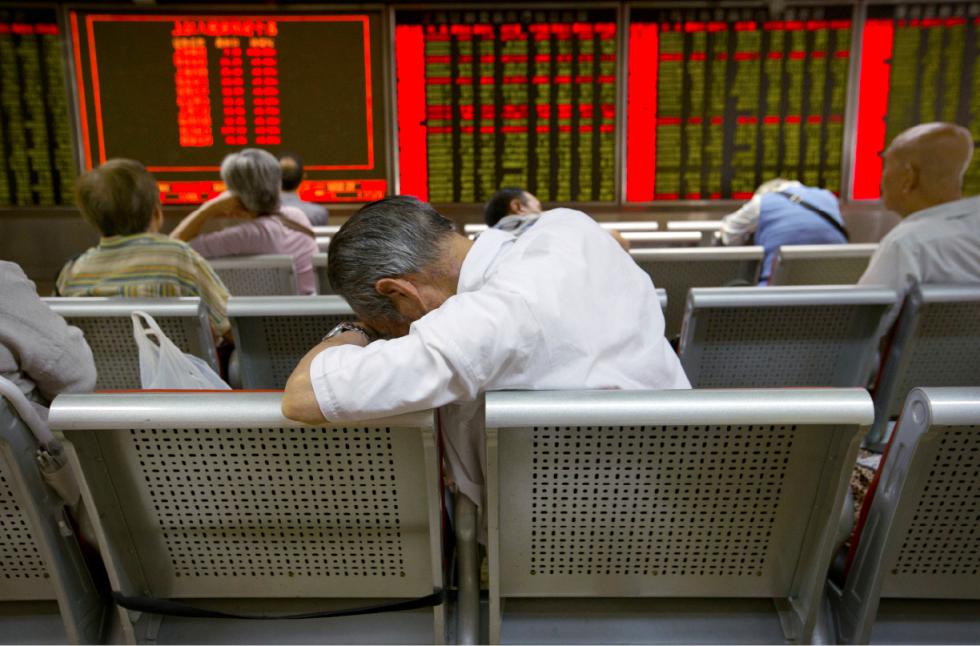 FILE - In this Tuesday, Aug. 25, 2015, file photo, Chinese investors monitor stock prices at a brokerage house in Beijing. Volatility in Chinese stocks roiled global markets this week, showing how big and closely-watched China's market has become - and reminding investors that stock markets can and do swing wildly. (AP Photo/Mark Schiefelbein, File) - Mark Schiefelbein | AP