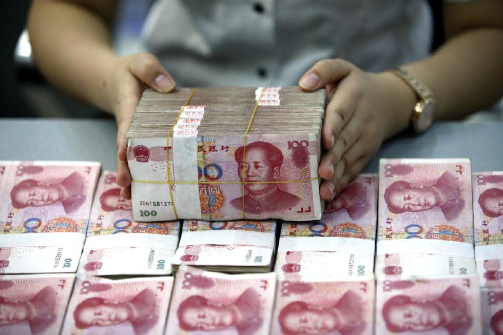 A bank clerk counts renminbi banknotes in a bank branch in Huaibei in central China's Anhui province Wednesday Aug. 26, 2015.   Asian stocks rose Wednesday after a rocky start following Beijing's decision to cut a key interest rate to help stabilize gyrating financial markets and free up more funding to counter short liquidity. (Chinatopix Via AP) CHINA OUT - CHINATOPIX
