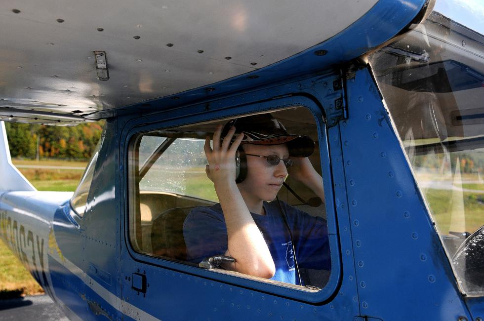 Glenn Rielly, 13, of Hartford, adjusts his headset before going up in a plane at Lebanon Municipal Airport  Wings and Wheels event in West Lebanon, N.H., on Sept. 27, 2014. The Experimental Aircraft Association Young Eagles Program gave free rides to about 100 kids during the day.  Valley News - Jennifer Hauck - Jennifer Hauck | Valley News
