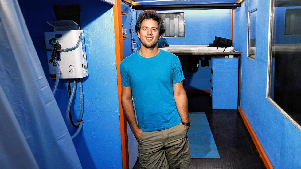 Luke Iseman inside his converted shipping container home in a warehouse in Oakland, California. Iseman and a group of friends have started a community living in converted cargo containers in response to high housing costs in the San Francisco Bay Area. Illustrates CALIF-HOUSING (category a) by John Gittelsohn and Prashant Gopal (c) 2015, Bloomberg News. Moved Thursday, July 30, 2015 (MUST CREDIT: Bloomberg News photo by Michael Short). - SHORT | BLOOMBERG NEWS