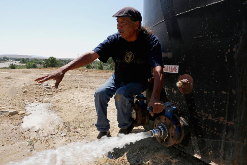 In this Aug. 18, 2015 photo, Joe Ben Jr., Shiprock Chapter House Farm Board representative, tests the water from tanks at the Chief Hill location in Shiprock, N.M. The quality of San Juan River water on the Navajo Nation has returned to what it was before a spill at a Colorado gold mine sent toxic sludge into the waterway, federal officials said Thursday. (Alexa Rogals/The Daily Times via AP) MANDATORY CREDIT - Alexa Rogals | The Daily Times