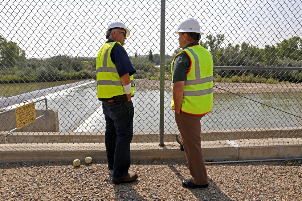 Bob Fredriksen, left, CH2M water operations manager, and David Sypher, public works director, look at the water pumping, Thursday, Aug. 20, 2015, at the Animas Pump Station No. 2 in Flora Vista, N.M. The quality of San Juan River water on the Navajo Nation has returned to what it was before a spill at a Colorado gold mine sent toxic sludge into the waterway, federal officials said Thursday. (Alexa Rogals/The Daily Times via AP) MANDATORY CREDIT - Alexa Rogals | The Daily Times
