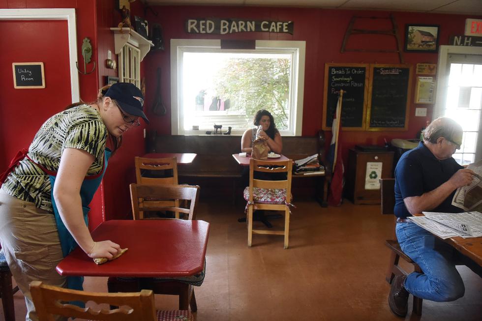 Christina Goding washes tables after a busy lunch crowd has left at the Red Barn Bakery and Cafe in Ascutney, Vt.,  on August 13, 2015.  (Valley News - Sarah Priestap) Copyright © Valley News. May not be reprinted or used online without permission. Send requests to permission@vnews.com. - Sarah Priestap | Valley News
