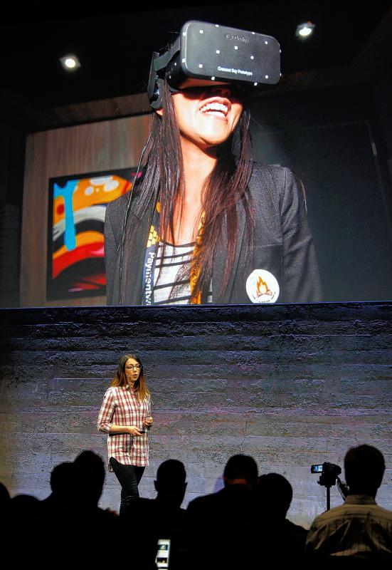 Anna Sweet, head of developer strategy at Oculus, helps introduces the Rift virtual reality headset during a media event at Oculus in San Francisco, Calif., on Thursday, June 11, 2015. (Karl Mondon/Bay Area News Group/TNS) - Karl Mondon | Contra Costa Times