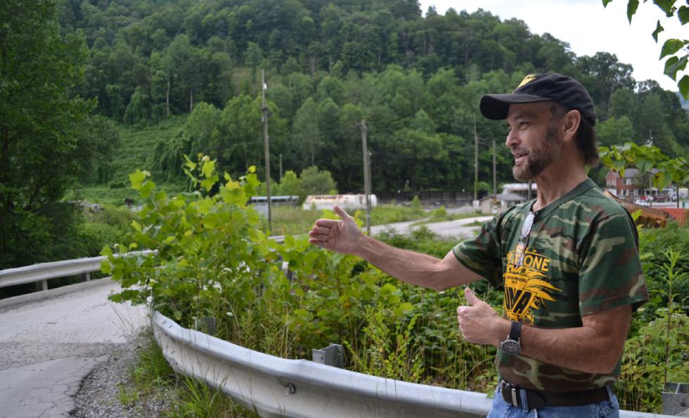 In this July 15, 2015 photo, Kenny Johnson, who joined in the Brookside mine strikes of the 1970s that were depicted in the Oscar-winning documentary "Harlan County USA," speaks to a reporter in Harlan, Ky. Johnson is standing on the spot in front of the mine where he was arrested for picketing in 1974. (AP Photo/Dylan Lovan) - Dylan Lovan | AP