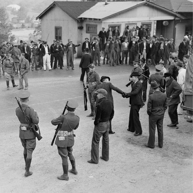 FILE - In this May 15, 1939 file photo, National Guardsmen stand guard over union strikers in Harlan County, Ky. The union era's death knell sounded in Kentucky on Dec. 31, 2014, when Patriot Coal announced the closing of its Highland Mine. (AP Photo/File) - AP