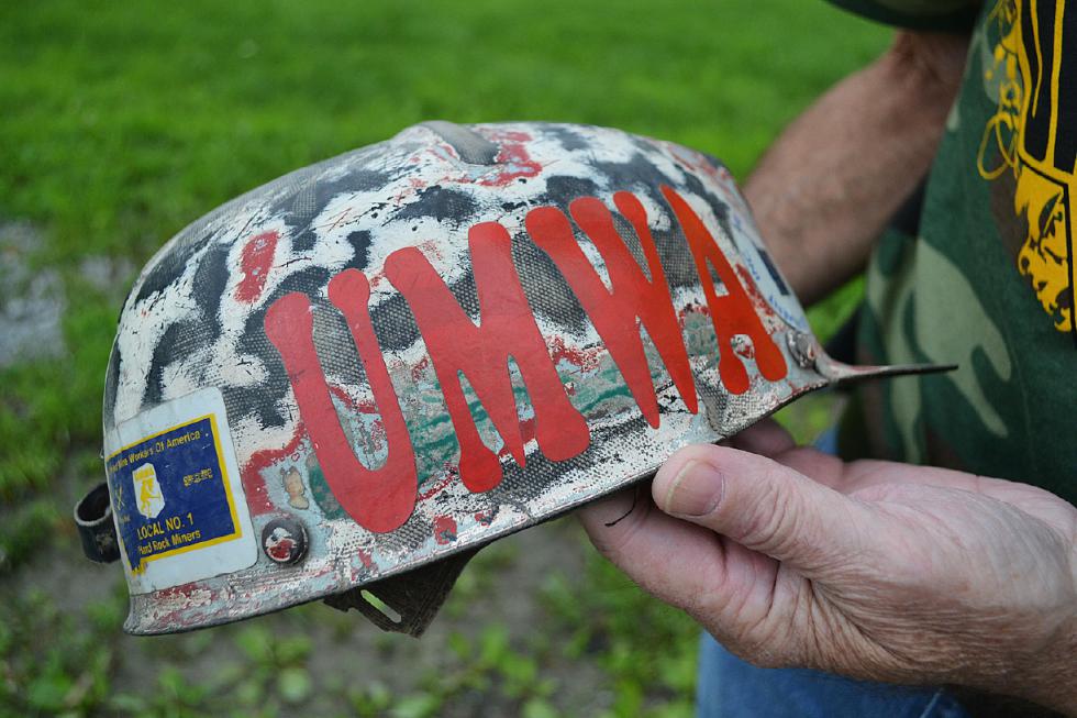 Kenny Johnson holds a coal miner's hardhat in Harlan County, Ky., on Wednesday, July 15, 2015. Johnson was given the hat by another union miner and Johnson used it until his retirement. Kentucky is now without a single union mine in the entire state after the closing of the Patriot Coal-owned Highland mine in December 2014. (AP Photo/Dylan Lovan) - Dylan Lovan | AP