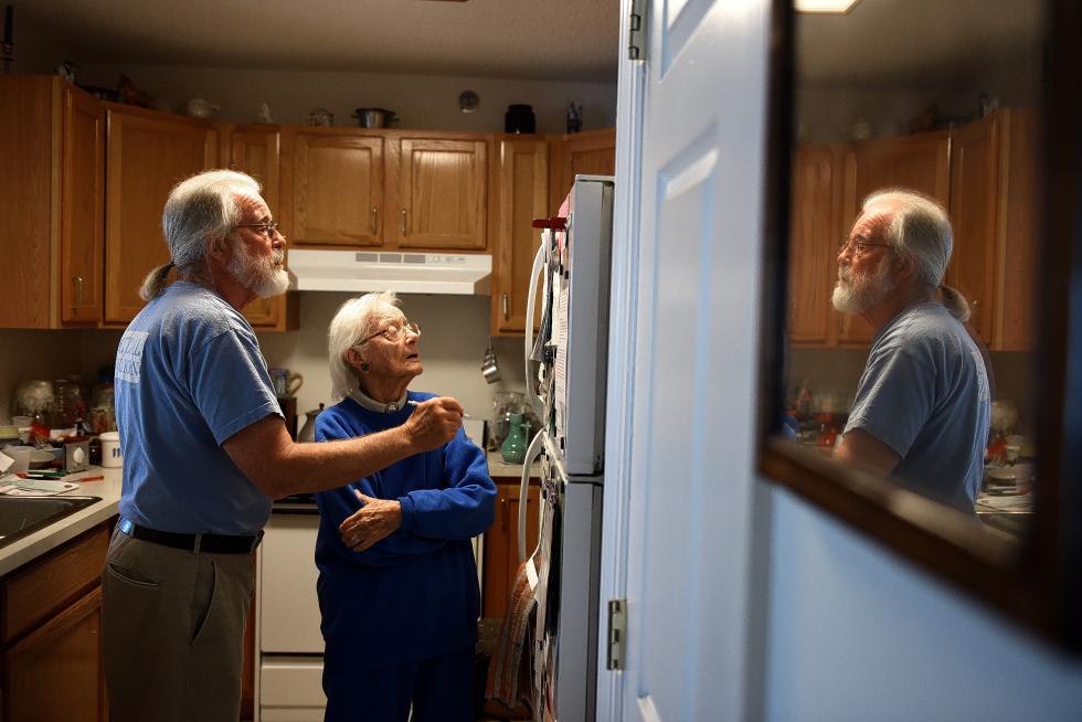 Jane Hammond and her son Lee Hammond look over a list of residents at her home in Harvest Hill in Lebanon, N.H. on Sept. 11, 2015. Jane Hammond, 104, was the first person to move into Harvest Hill 20 years ago.(Valley News - Jennifer Hauck) <p><i>Copyright © Valley News. May not be reprinted or used online without permission. Send requests to permission@vnews.com.</i></p> - Jennifer Hauck | Valley News
