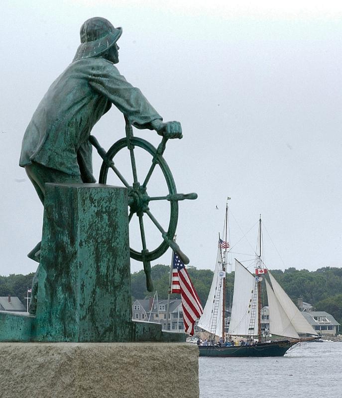FILE - In this Aug. 31, 2007 file photo, the Fisherman's Memorial Statue overlooks the harbor in Gloucester, Mass., as the schooner Thomas E. Lannon sails past on the first day of the 23rd annual Gloucester Schooner Festival. Gloucester was one of the earliest fishing ports in the country after a group of Englishmen, attracted by the deep waters and abundance of codfish, landed there in 1623 to fish and to establish a settlement. The city remained a fishing center but the industry declined there through most of the 20th century. (AP Photo/Lisa Poole, File) - Lisa Poole | AP