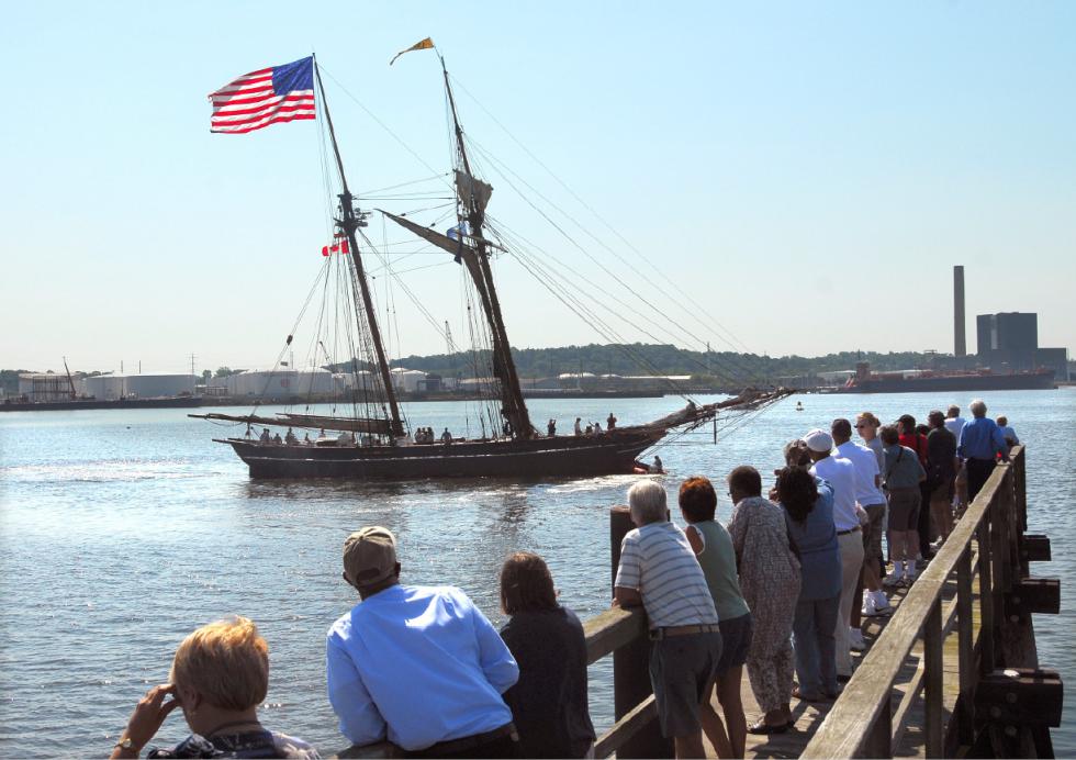 In this June 21, 2008 photo, a crowd watches the replica schooner Amistad returning home to New Haven, Conn., after a yearlong world tour. The replica ship serves as a symbol of America's early anti-slavery movement. Enslaved Africans aboard the original Spanish ship named Amistad revolted in 1839, seizing it and sailing up the East Coast. (Peter Casolino/New Haven Register via AP) MANDATORY CREDIT - Peter Casolino | New Haven Register