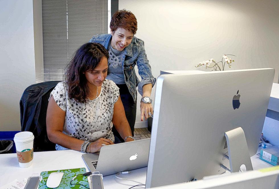 Stella&Dot's Meera Bhatia, left, vice president of product, and Christy Dinges, vice president of people, check their Facebook at Work page at their office on Sept. 28, 2015 in San Bruno, Calif. Their company started testing the new Facebook at Work product a couple months ago. (Karl Mondon/Bay Area News Group/TNS) - Karl Mondon | San Jose Mercury News