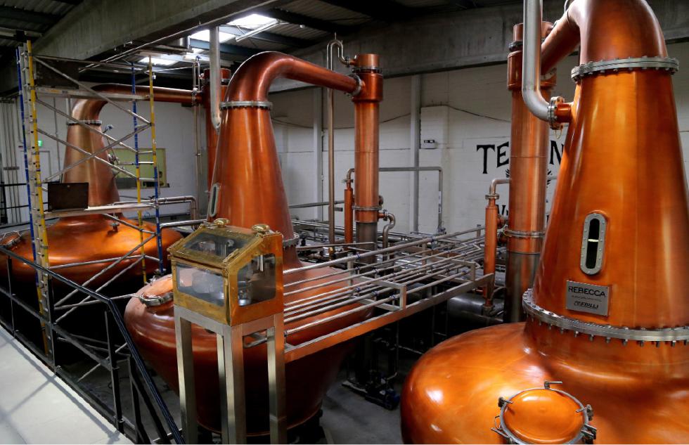 This Sept. 9, 2015 photo shows Teeling Whiskey's three copper stills, crucial to the tradition of triple-distilling Irish whiskey for smoothness. Dublin's newest distillery celebrated its grand opening in 2015, after a hiatus of nearly 40 years. (AP Photo/Michelle Locke) - Michelle Locke | AP
