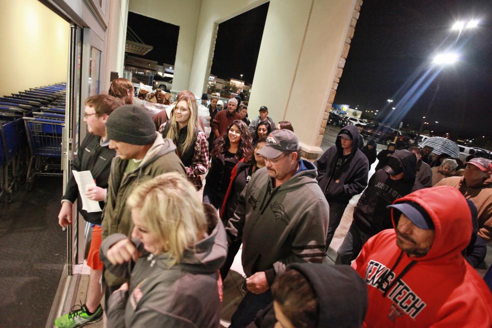 Shoppers rush through the entrance to the Academy Sports+Outdoors at 5:00 a.m. in the Chimney Rock Shopping Center on Friday, Nov. 27, 2015, in Odessa, Texas. Early numbers arent out yet on how many shoppers headed to stores on Thanksgiving, but its expected that more than three times the number of people will venture out to shop on the day after the holiday known as Black Friday. (Jacob Ford/Odessa American via AP) MANDATORY CREDIT - Jacob Ford | Odessa American