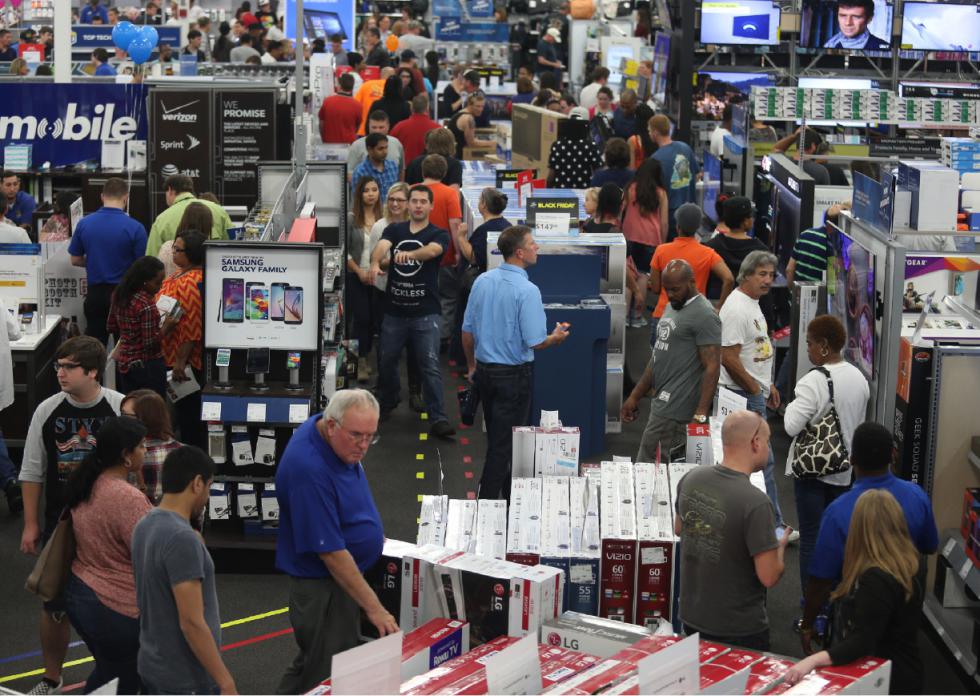People look at merchandise while holiday shopping at Best Buy on Thursday, Nov. 26, 2015, in Panama City, Fla. Early numbers arent out yet on how many shoppers headed to stores on Thanksgiving, but its expected that more than three times the number of people will venture out to shop on the day after the holiday known as Black Friday. (Patti Blake/News Herald via AP) MANDATORY CREDIT - Patti Blake | News Herald