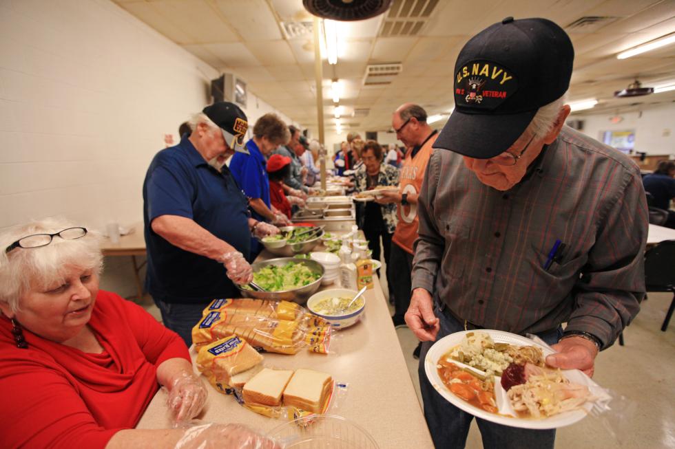 Veterans and their families line up to fill their plates with Thanksgiving food at the Veterans of Foreign Wars Post 4372 on Thursday, Nov. 26, 2015, in Odessa, Texas. (Jacob Ford/Odessa American via AP) MANDATORY CREDIT - Jacob Ford  | Odessa American