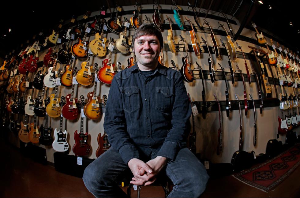 Brian Douglas is photographed at the Cream City Music store Wednesday, Nov. 11, 2015, in Brookfield, Wis. Cream City Music sells more than 1,800 items from guitar picks to vintage instruments on Reverb.com, a musical equipment marketplace. The retailer began selling on Reverb.com two years ago. Small retailers use high-tech innovations to build relationships with customers; they often can't compete with big chains on prices, so they aim at better, individualized service.  (AP Photo/Morry Gash) - Morry Gash | AP