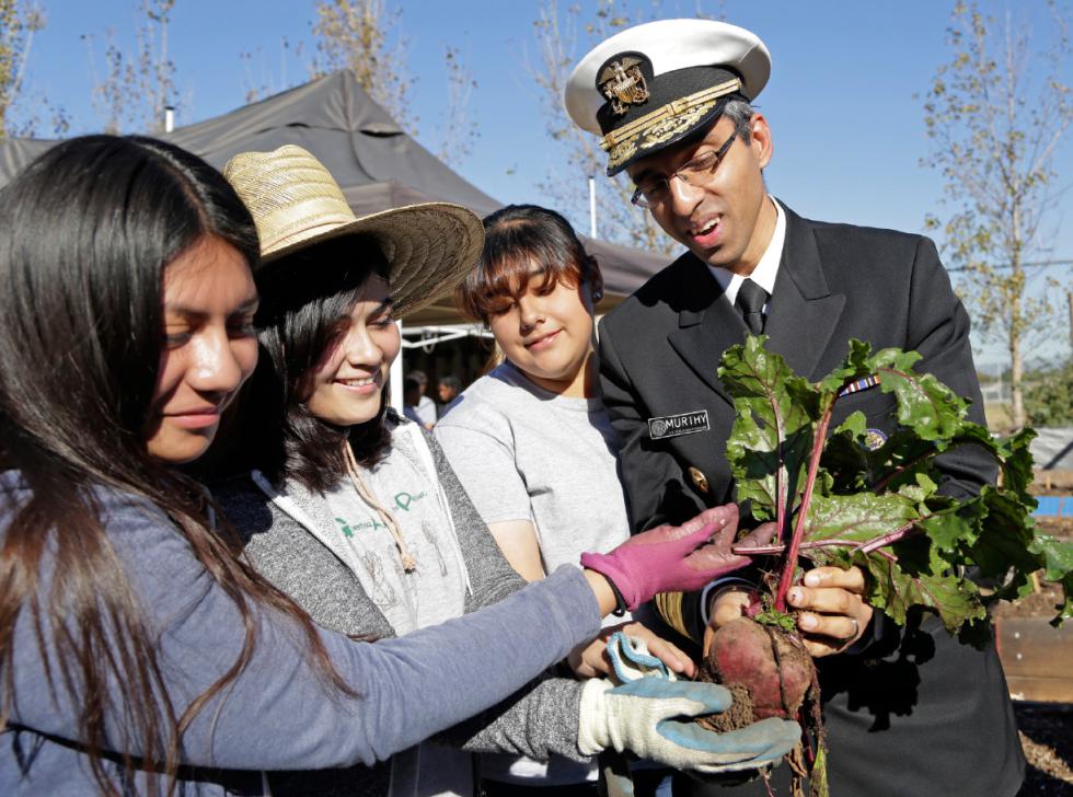 U.S. Surgeon General Vivek Murthy and John C. Fremont High School students hold a beet grown in the school's Gardening Apprenticeship Program plot on the campus south of downtown Los Angeles Friday, Nov. 20, 2015. Murthy visited the partnership between community organizations and the high school to support healthy initiatives in neighborhoods starved for fresh produce and grappling with childhood obesity. Students involved in the 12-week after-school gardening apprenticeship program learn to grow food and cook healthy dishes, pulling from kumquat and lime trees and planters filled with potatoes, peas and beets.(AP Photo/Nick Ut) - Nick Ut | AP