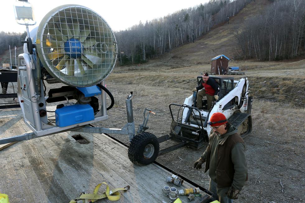Whaleback Head Snowmaker Andy Pysz, of Newport, N.H., right, and Mountain Manager Gerd Riess, of Thetford, Vt., prepare to unload a refurbished fan gun for snowmaking at the Enfield, N.H., ski hill on December 19, 2015. They were preparing for a 12-hour overnight snowmaking shift later in the day, their first of the season. (Valley News - Geoff Hansen)Copyright © Valley News. May not be reprinted or used online without permission. Send requests to permission@vnews.com. - Geoff Hansen | Valley News