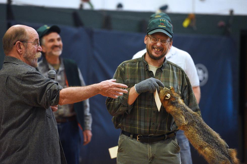 Auctioneer Chuck Eaton, of West Fairlee, Vt., jokes with David Perrin, of Braintree, Vt., while auctioning a fox pelt during the semi-annual fur auction at Whitcomb High School in Bethel, Vt.,  on December 12, 2015. Eaton kept buyers and sellers laughing with many jokes, especially helpful due to a low price year for furs.  (Valley News - Sarah Priestap) Copyright © Valley News. May not be reprinted or used online without permission. Send requests to permission@vnews.com. - Sarah Priestap | Valley News