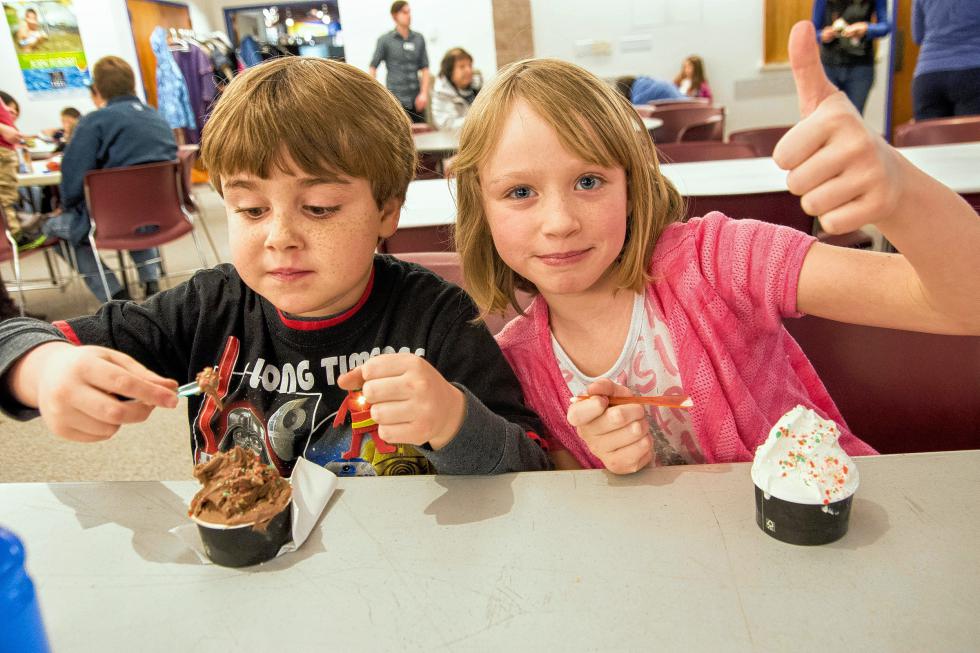 Cousins Griffin Stoudnour, 7, of Fairlee, and Isabel Shiers, 8, of Norway, Maine, compare the taste of Pop Rocks on different flavors of Morano Gelato during the Montshire Museum of Science's 40th anniversary celebration on Jan. 10. Nancy Nutile-McMenemy photograph  (www.photosbynanci.com) - Nancy Nutile-McMenemy |
