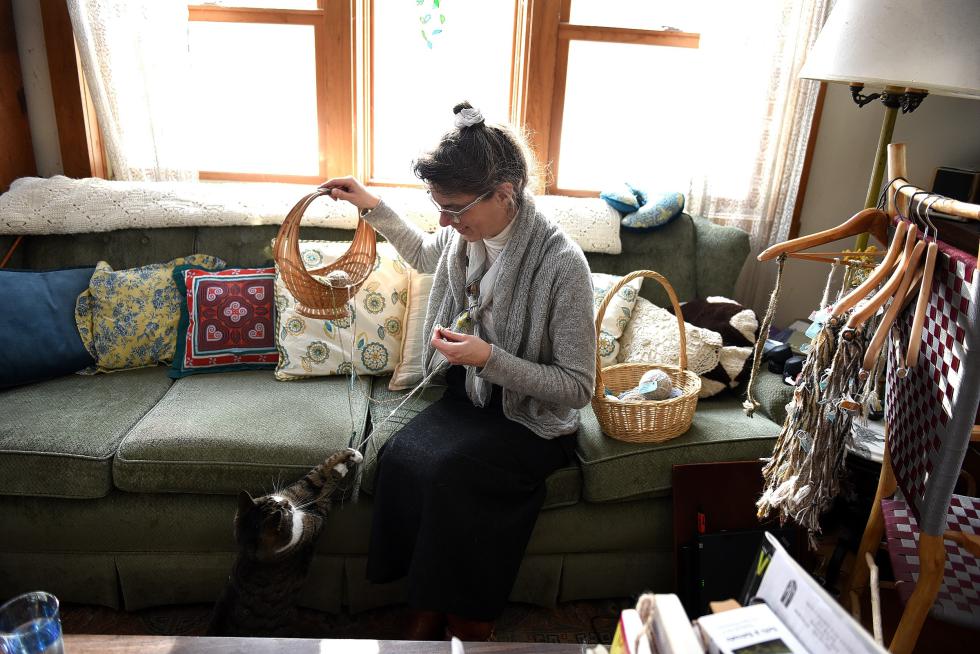 Dawn Hancy's cat chases the yarn she was using for her boot bracelets at her home in Vershire, Vt., on Jan. 7, 2016. (Valley News - Jennifer Hauck) Copyright © Valley News. May not be reprinted or used online without permission. Send requests to permission@vnews.com. - Jennifer Hauck | Valley News