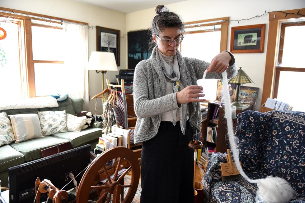 Dawn Hancy uses a drop spindle to make yarn from alpaca wool at her home in Vershire, Vt., on Jan. 7, 2016. (Valley News - Jennifer Hauck) <p><i>Copyright © Valley News. May not be reprinted or used online without permission. Send requests to permission@vnews.com.</i></p> - Jennifer Hauck | Valley News